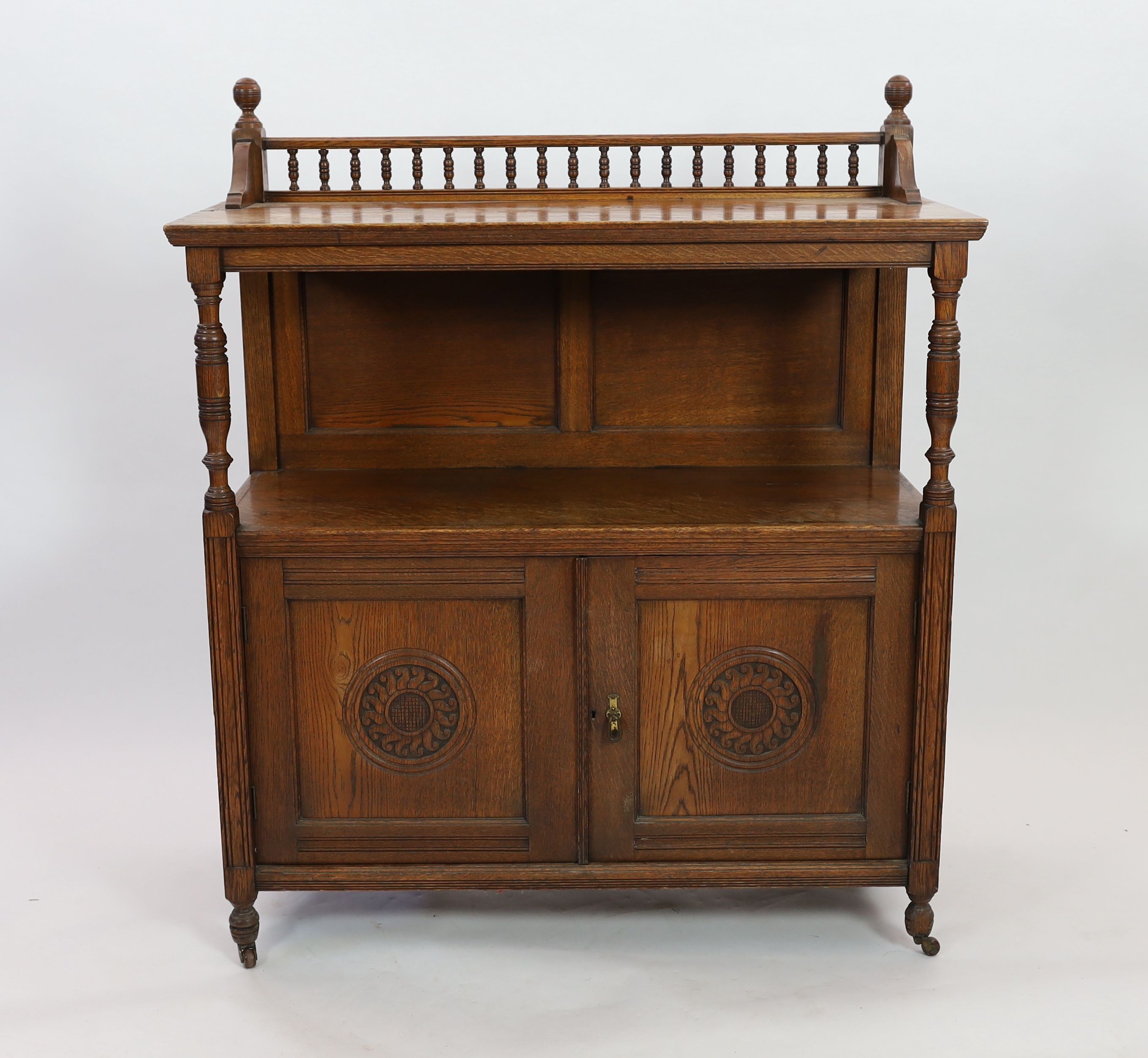 A late Victorian oak buffet, width 113cm depth 47cm height 133cm